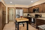 The kitchen is well equipped with modern appliances and a butcher block for meal prep